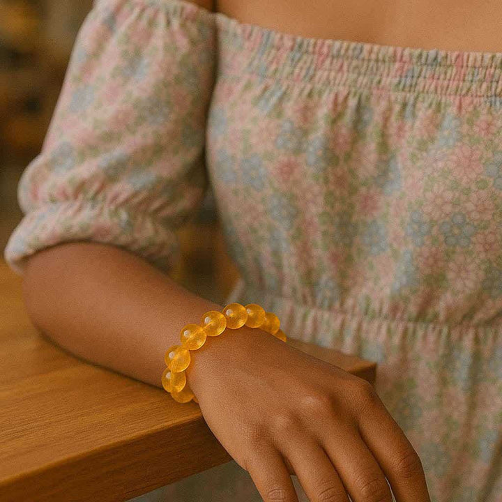 Citrine bead bracelet worn on a wrist